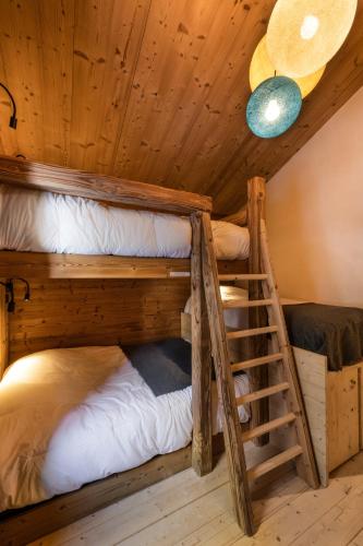 a room with two bunk beds and a ladder at Club Alpina - Champagny-en-Vanoise in Champagny-en-Vanoise