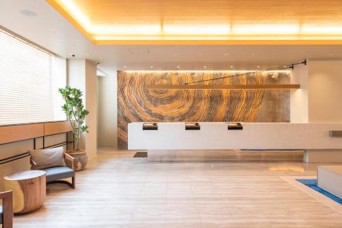 a lobby with a large painting on the wall at Hotel Forza Nagoya Sakae in Nagoya
