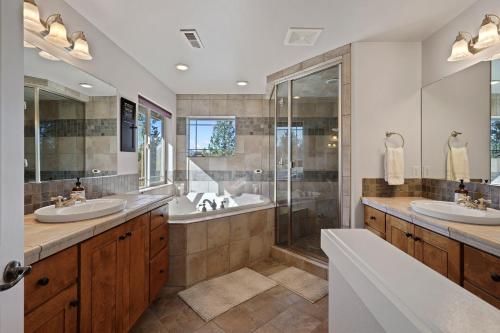 a bathroom with two sinks and a shower at Flagline Trail home in Bend