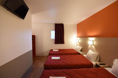 a hotel room with two beds and a television at Première Classe Rosny Sous Bois in Rosny-sous-Bois