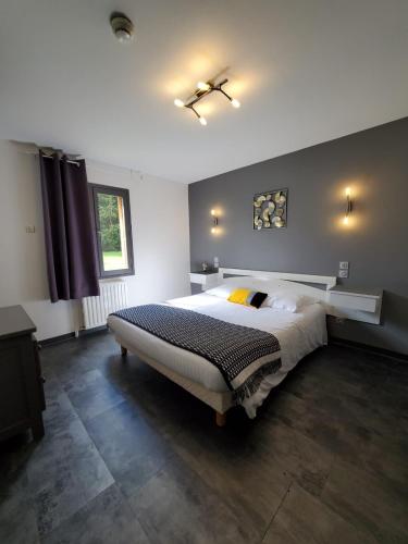a bedroom with a large bed in a room at Les Cèdres Bleus in Aurec-sur-Loire