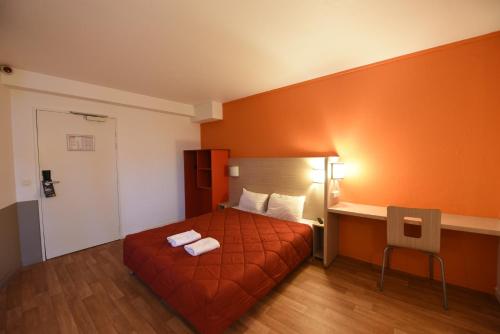 a hotel room with a bed with two towels on it at Première Classe Rosny Sous Bois in Rosny-sous-Bois