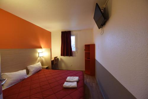 a hotel room with a bed with two towels on it at Première Classe Rosny Sous Bois in Rosny-sous-Bois