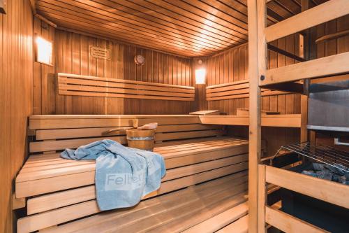 a wooden sauna with a towel sitting on a bench at Felbermayer´s Bed & Breakfast in Gaschurn
