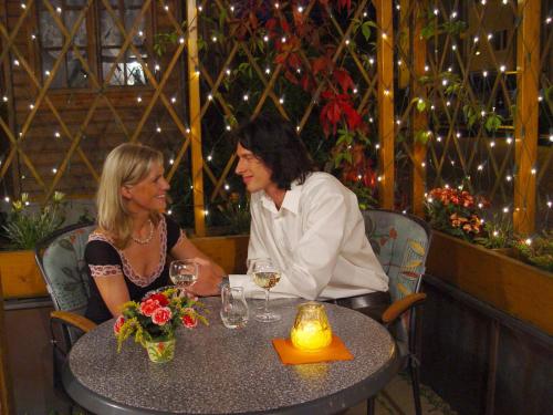 two women sitting at a table in a restaurant at Parkhotel Helene in Bad Elster