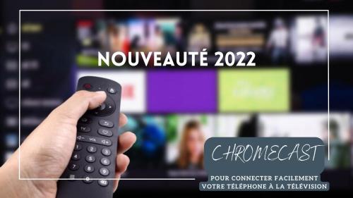 a person holding a remote control in front of a television at Kyriad Montpellier Ouest St Jean de Védas - A709 in Saint-Jean-de-Védas