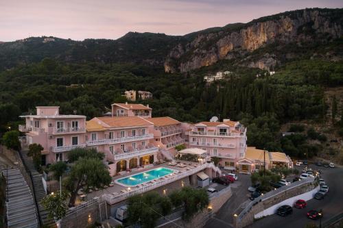 an aerial view of a house with a swimming pool at Odysseus Hotel in Paleokastritsa
