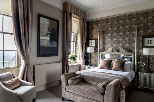 a bedroom with a bed and a chair at Wood Hall Hotel & Spa in Wetherby