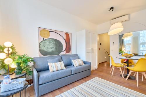 a living room with a blue couch and a table at Maison Grand Place Studio 4 in Brussels