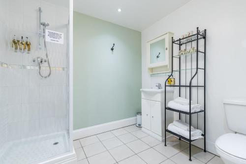 a bathroom with a shower and a toilet at The Littleton Arms in Penkridge