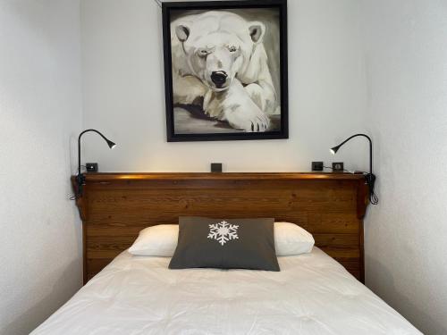 a bed with a picture of a polar bear on the wall at Club Alpina - Champagny-en-Vanoise in Champagny-en-Vanoise