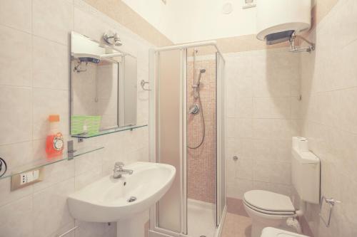 a bathroom with a sink and a toilet and a shower at Sanremo City Center II by Wonderful Italy in Sanremo