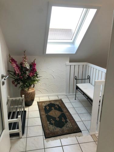 a room with a skylight and a vase of flowers on the floor at Ferienwohnung Wiskow in Goslar in Goslar