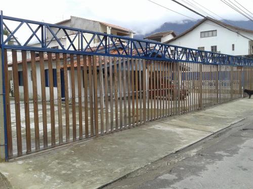 a metal fence in front of a house at Pousada Edson in Caraguatatuba