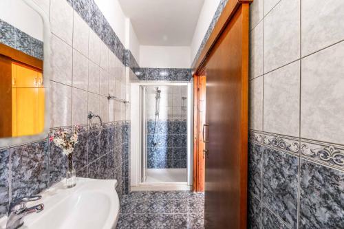a bathroom with a sink and a shower at Villa Wisteria in Lachi