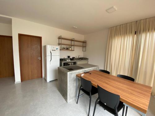 a kitchen and dining room with a table and a refrigerator at Fontes da Pipa by Liiv in Pipa