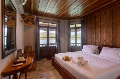 a bedroom with a large bed with towels on it at Koh Tao Relax Freedom Beach Resort in Ko Tao