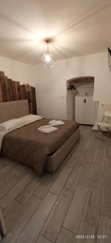 a bedroom with a bed and a wooden floor at Tresca Vecchia in Bari