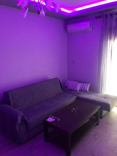 a living room with a couch and a table at The only luxurious apartment in the center of town in Kilkís