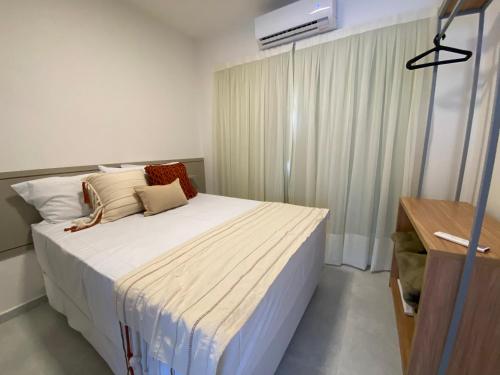 a bedroom with a large bed with white sheets at Fontes da Pipa by Liiv in Pipa