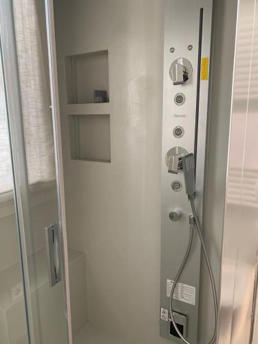 a shower in a bathroom with a glass door at Azapartments in Treviso