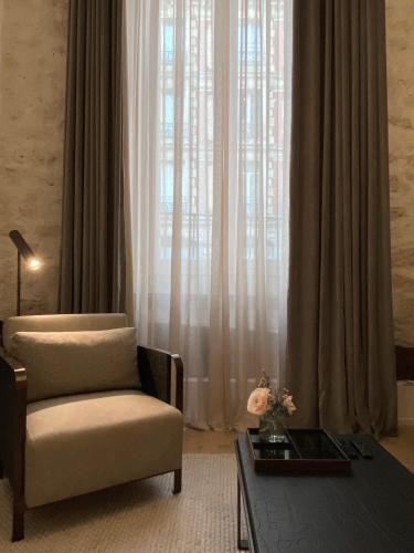 - un salon avec une chaise et une table basse dans l'établissement DLM Paris, à Paris