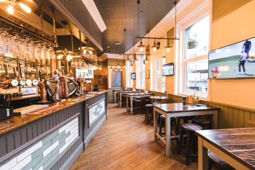 a restaurant with tables and chairs and a bar at Black Lion Hotel in Manchester