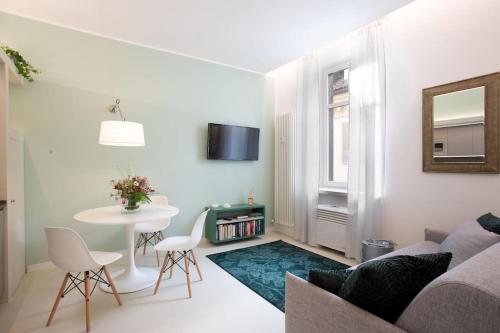 a living room with a couch and a table at Santa Chiara Suite in Turin