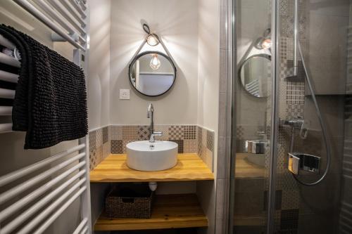 a bathroom with a sink and a shower at Chalet Le Loup Blanc in Les Orres