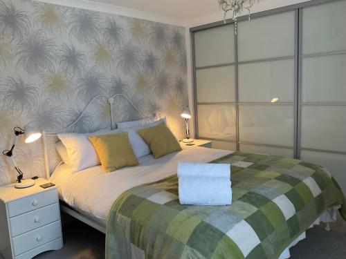 a bedroom with a large bed with yellow pillows at Pass the Keys 3 bedroom home within walking distance of town in Shrewsbury