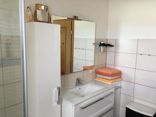 ein Bad mit einem Waschbecken und einem Spiegel in der Unterkunft Ferienwohnung Dünensand in Kühlungsborn
