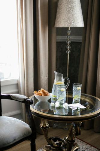 a table with a vase and a bowl of food on it at Mediterranean Palace in Thessaloniki