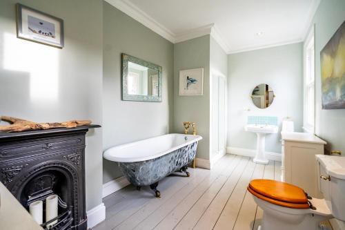 a bathroom with a tub and a toilet and a sink at 7 St John's Crescent in York