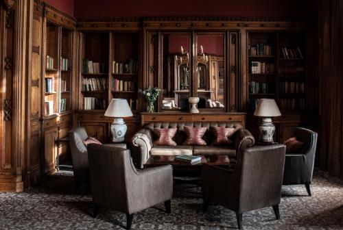 a living room with a couch and two chairs at Nutfield Priory Hotel & Spa in Redhill