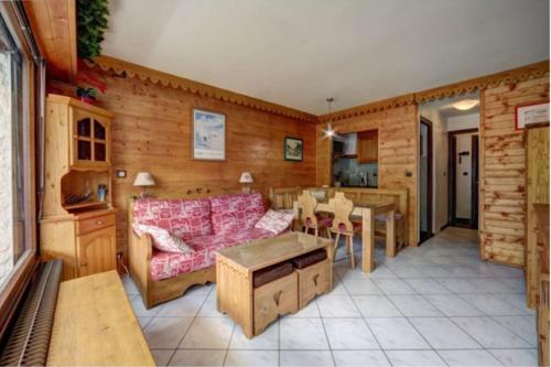 a living room with a couch and a table at Studio with balcony in the center of the village in Le Grand-Bornand
