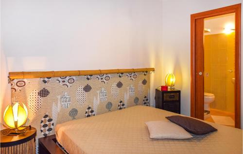 a bedroom with a bed and a bathroom with a mirror at Villa Cristiana in Scoglitti