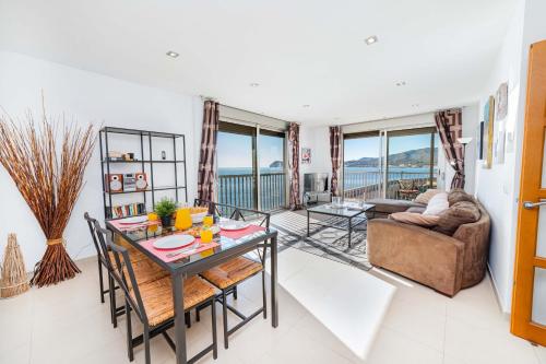 a living room with a table and a couch at Apartamento Bellavista Puerto 2A in Cala Ratjada