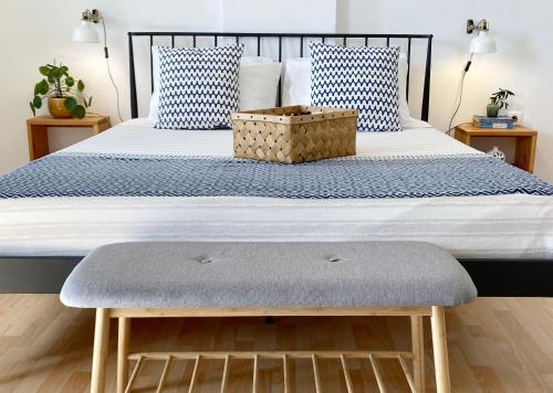 a bed with a bench at the foot of it at Asterias in Panteli