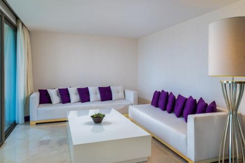 a living room with two couches and purple pillows at Hillstone Bodrum Hotel & Spa in Bodrum City