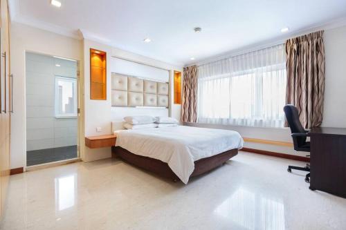 a hotel room with a bed and a television at The Center of Singapore; China Town in Singapore
