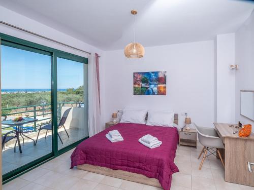 a bedroom with a bed and a balcony at Marilena Luxury Sea View Private Villa in Gouves