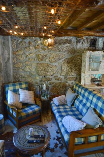a living room with two couches and a table at Casa do Ti João in Sabugueiro