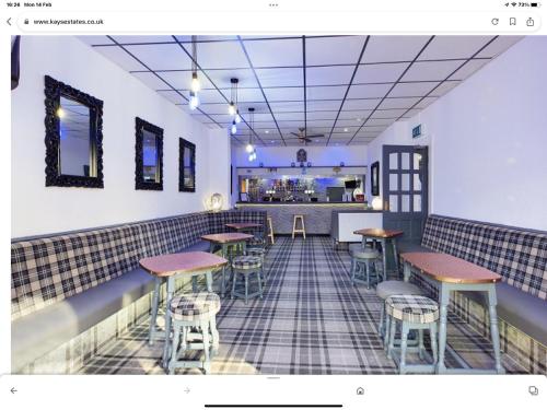 a room with tables and stools in a restaurant at The Danescourt in Blackpool