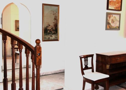 a stairway with a desk and a chair next to a staircase at Barony Le Pergole holiday apartments Lugano in Lugano