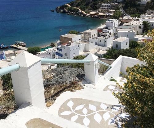 a view of a town with white buildings and the ocean at Asterias in Panteli