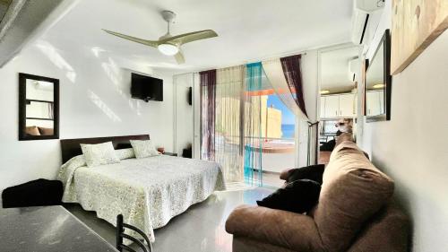 salon z łóżkiem i kanapą w obiekcie Bulto Carihuela w mieście Torremolinos