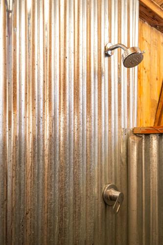 a metal wall with a shower in a bathroom at Madagascar Underground in Antananarivo