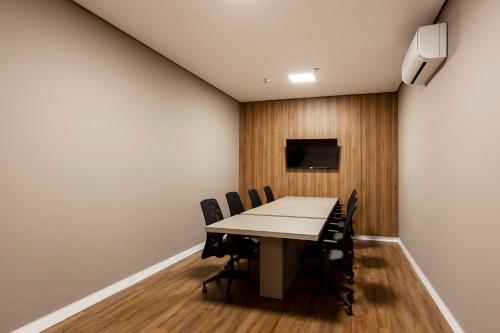 a conference room with a table and chairs at Slaviero Rondonópolis Centro in Rondonópolis