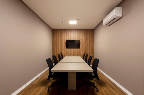 a conference room with a long table and chairs at Slaviero Rondonópolis Centro in Rondonópolis