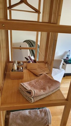 a wooden shelf with some items on a wooden floor at Feinzimmer mit Feinkost & Wein in Marquartstein